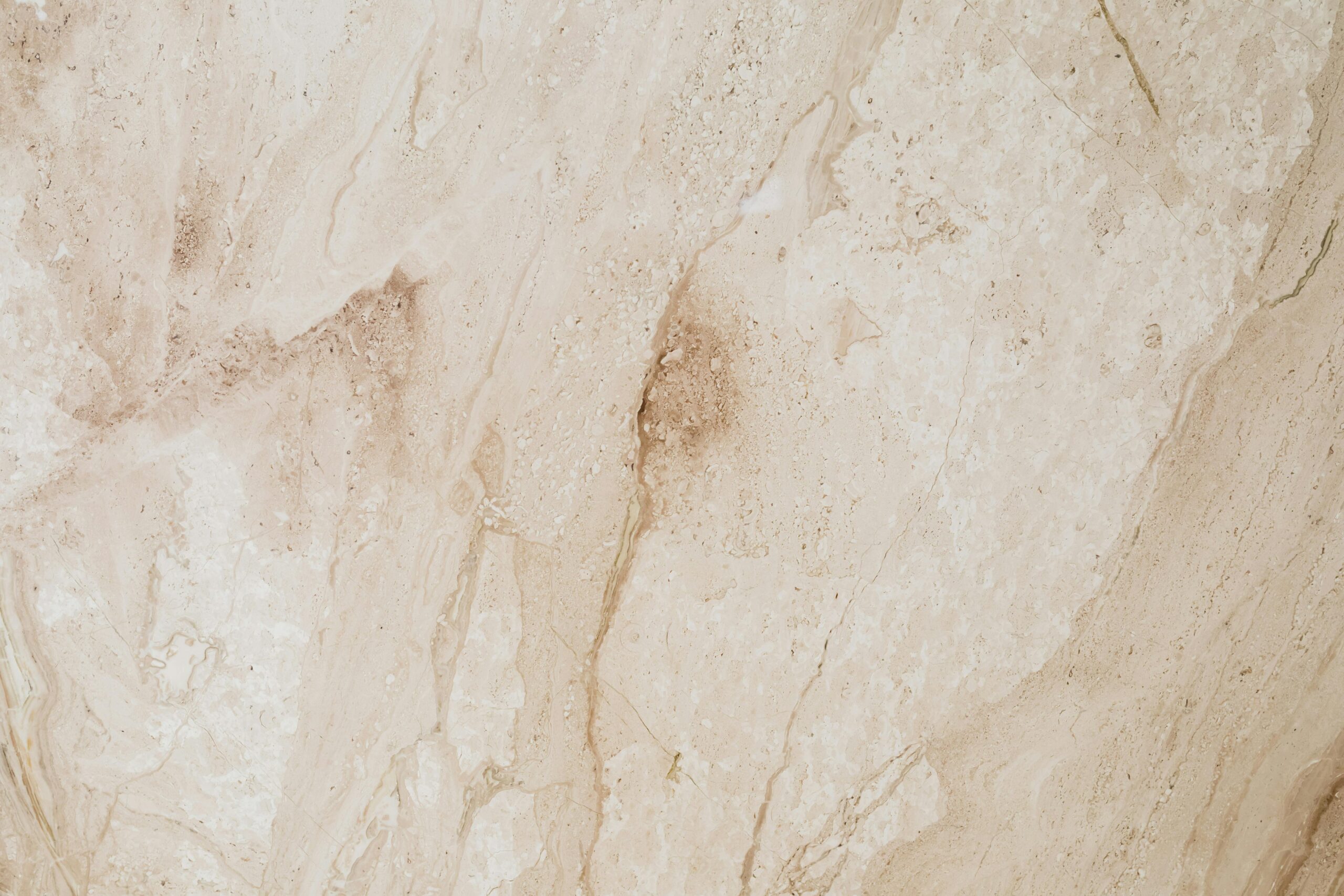 High-resolution beige marble texture with natural patterns, ideal for backgrounds and wallpaper.